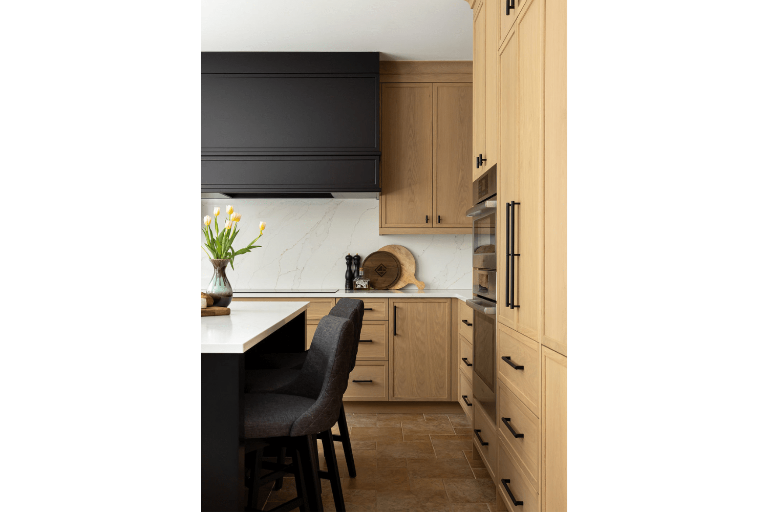 White oak kitchen cabinets with black range hood