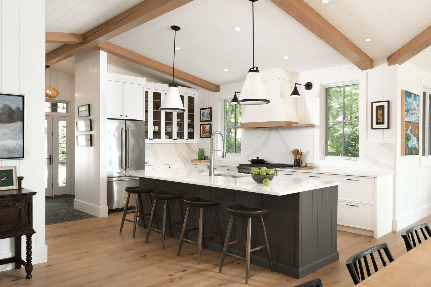 Cottage kitchen with white cabinets and black kitchen island
