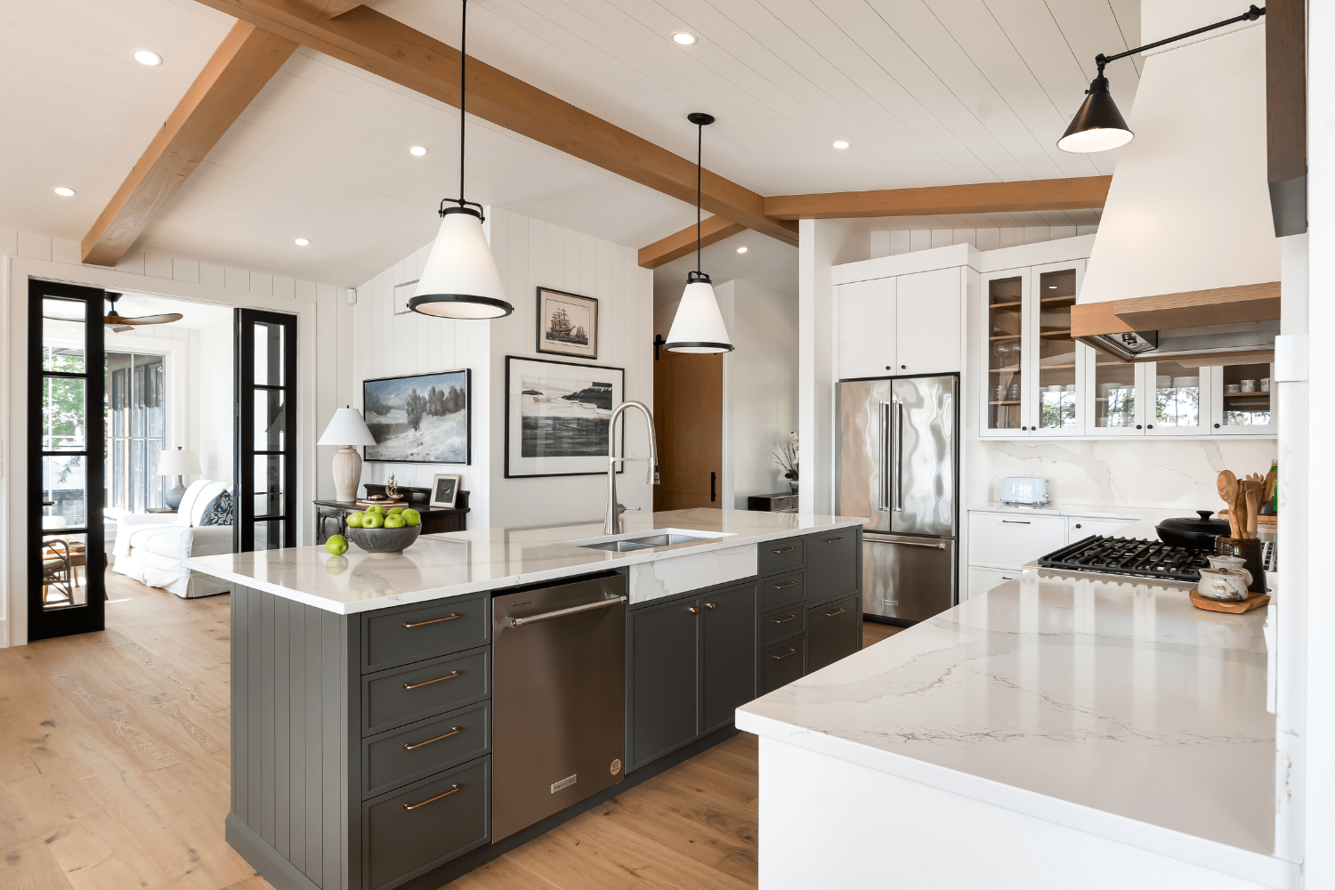 Narrow shaker drawers with brass pulls on black kitchen island