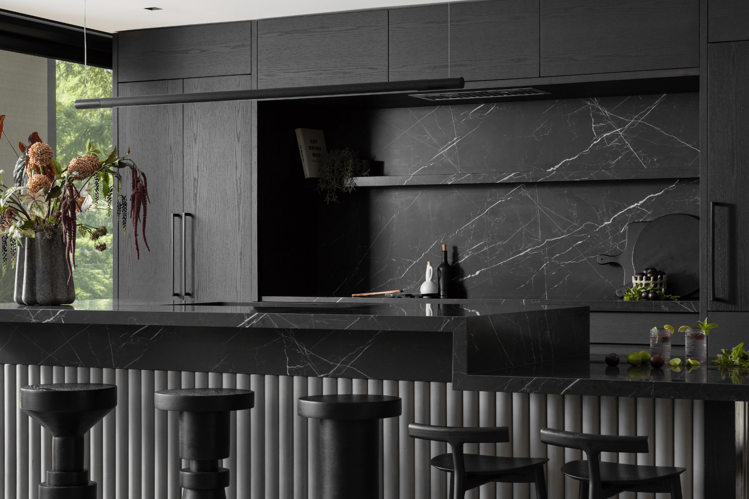 Luxury black kitchen design with two-tier dining kitchen island