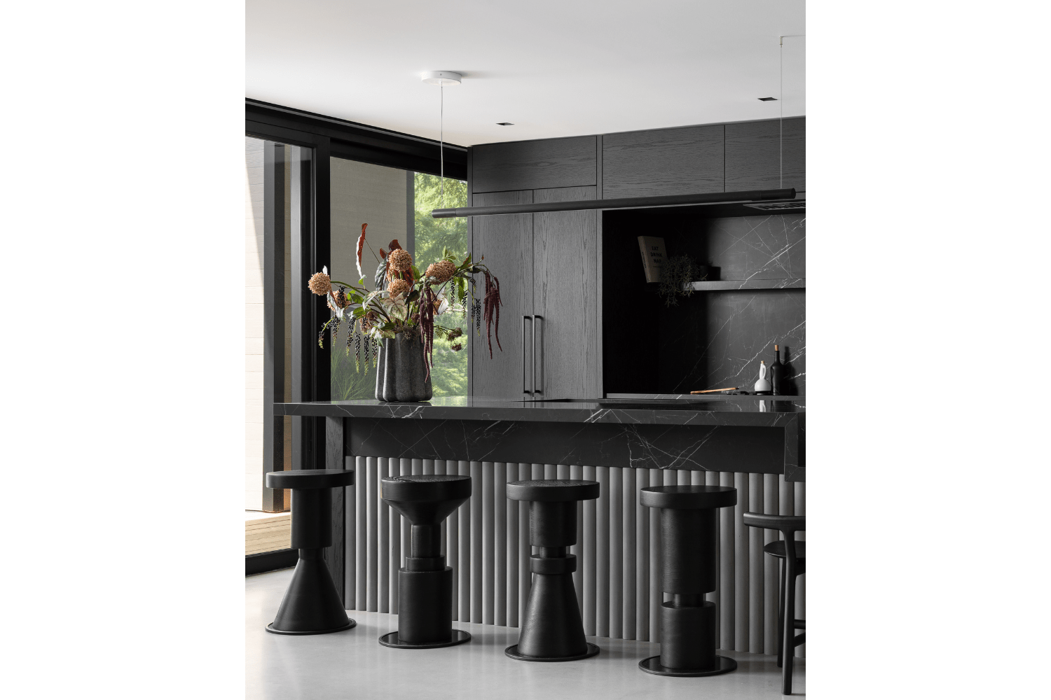 Contemporary black moody kitchen design with seating