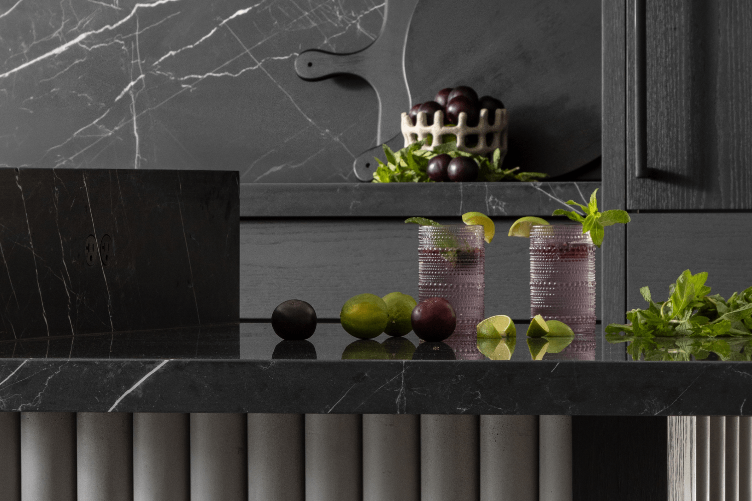 Hidden bocci outlet integrated into black kitchen island counter