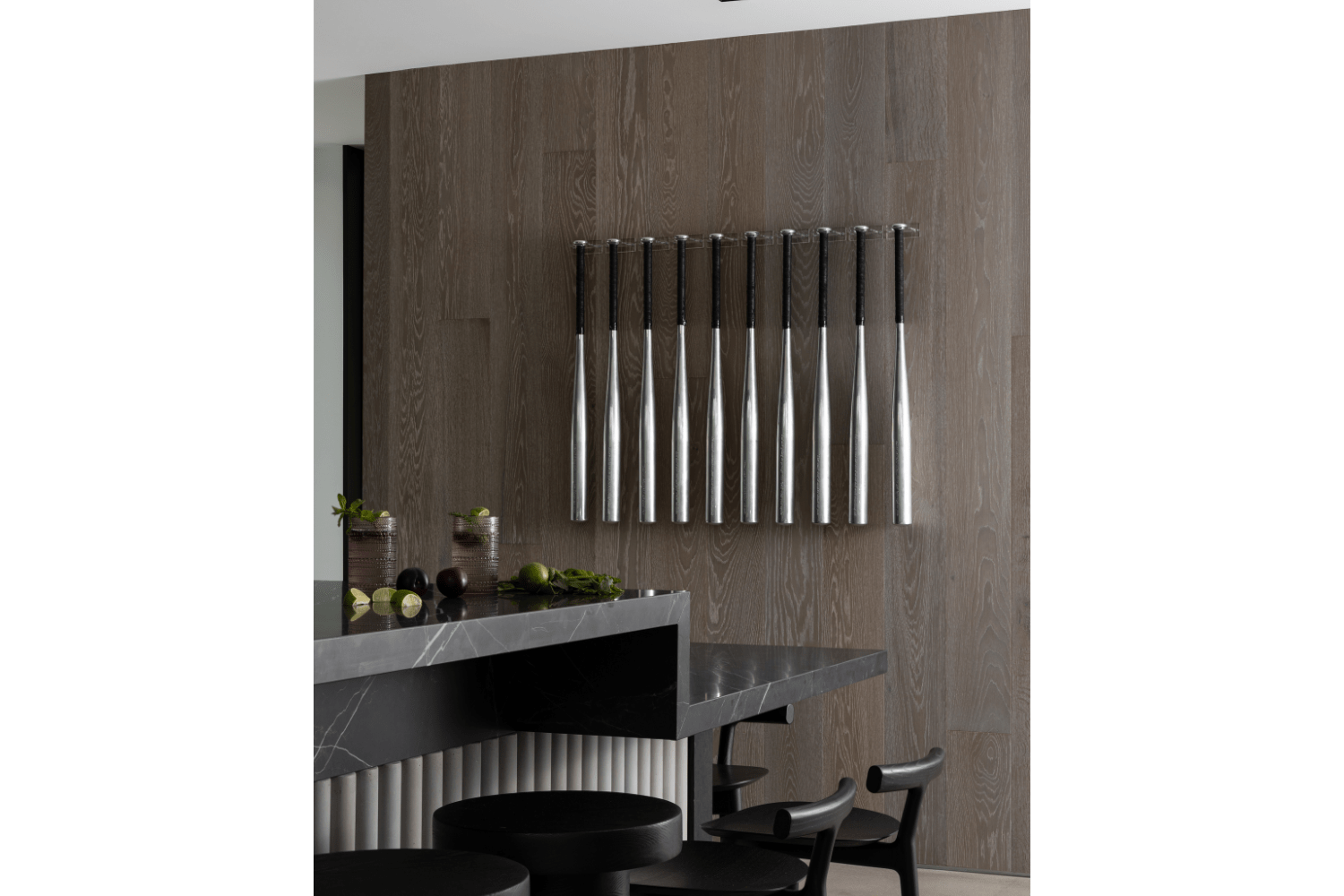 Kitchen accent wall next to black kitchen island with stone reed