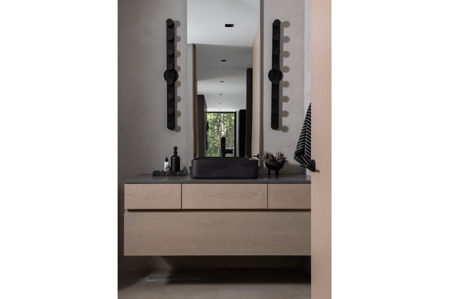 Contemporary floating white oak bathroom vanity with dark stone 