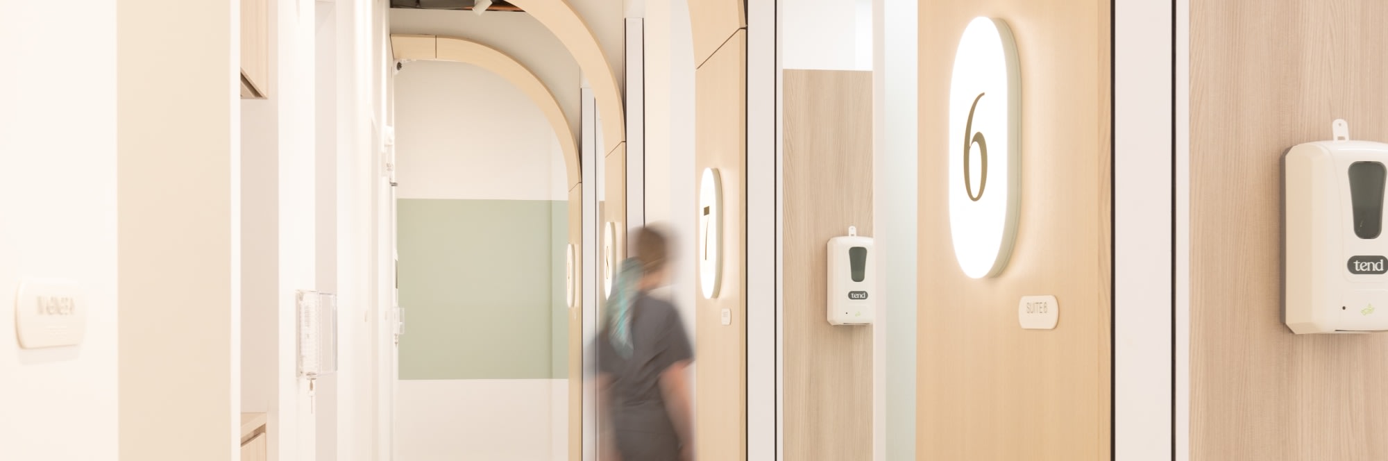 Long hallway with a blurred walking dental professional.