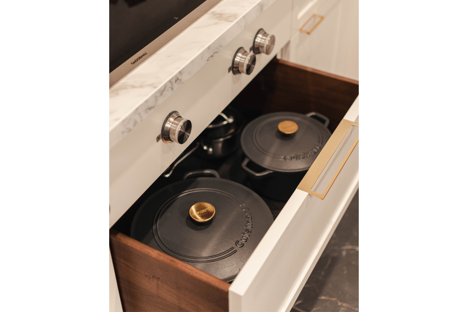 Functional kitchen drawer located under the cook top for pots an