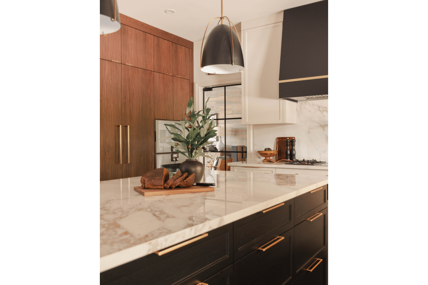 white, black, and walnut kitchen design with brass accents