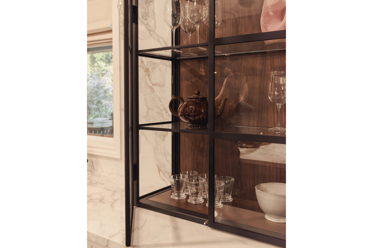 Countertop hutch with black metal framed glass doors and walnut