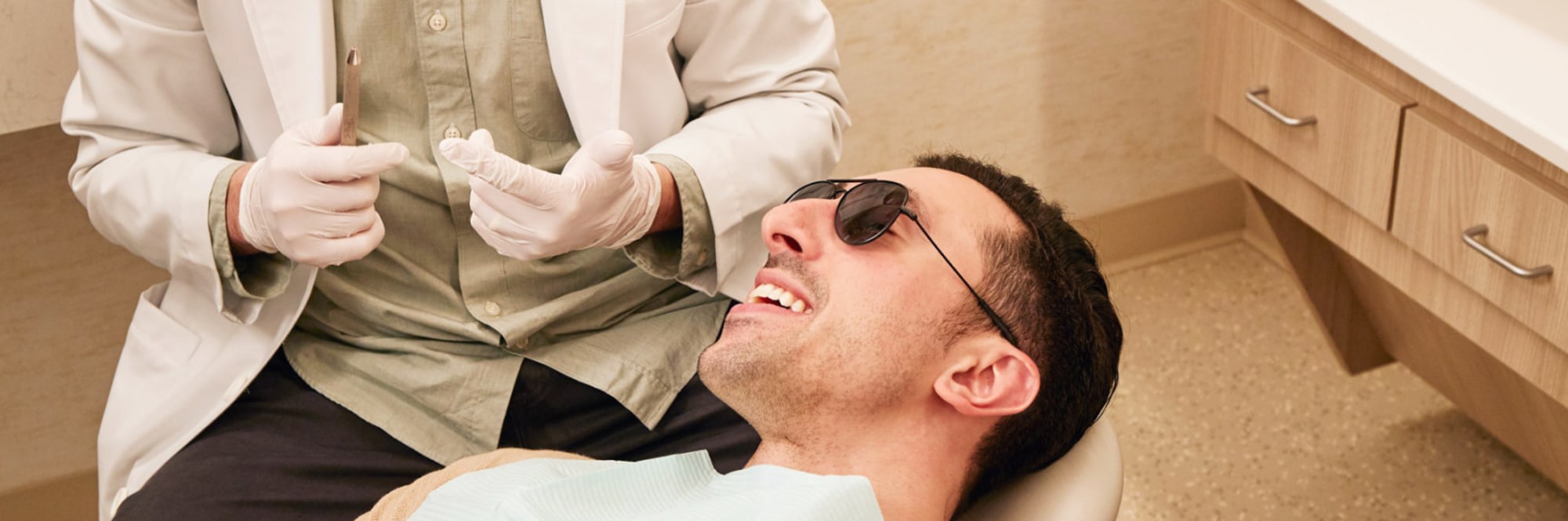 Dental professional performing treatment on a patient.
