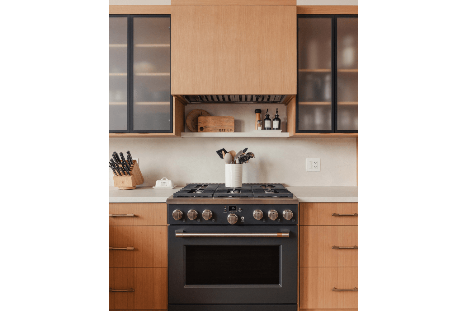 Custom red oak range hood with quartz floating shelf