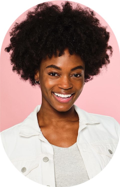 Woman with curly hair and a white shirt smiling
