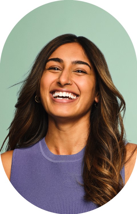 A young woman with long hair is smiling.