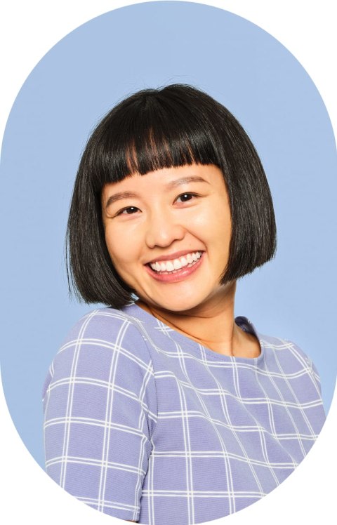 A woman with a short dark bob smiles.