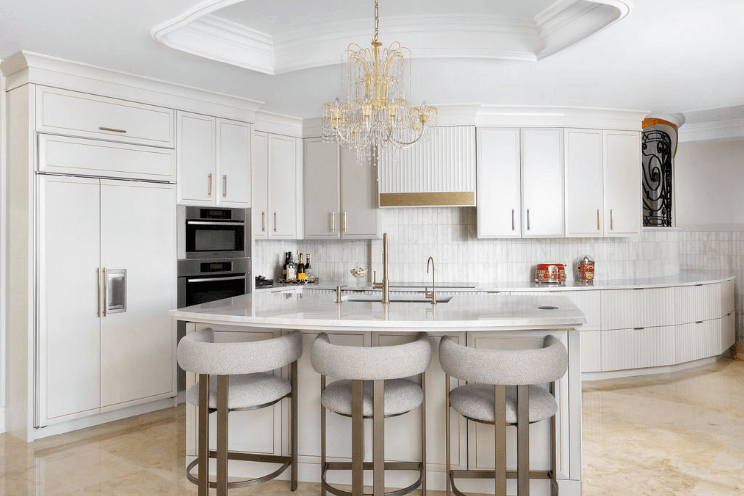 Cream and gold transitional kitchen with fluted cabinetry