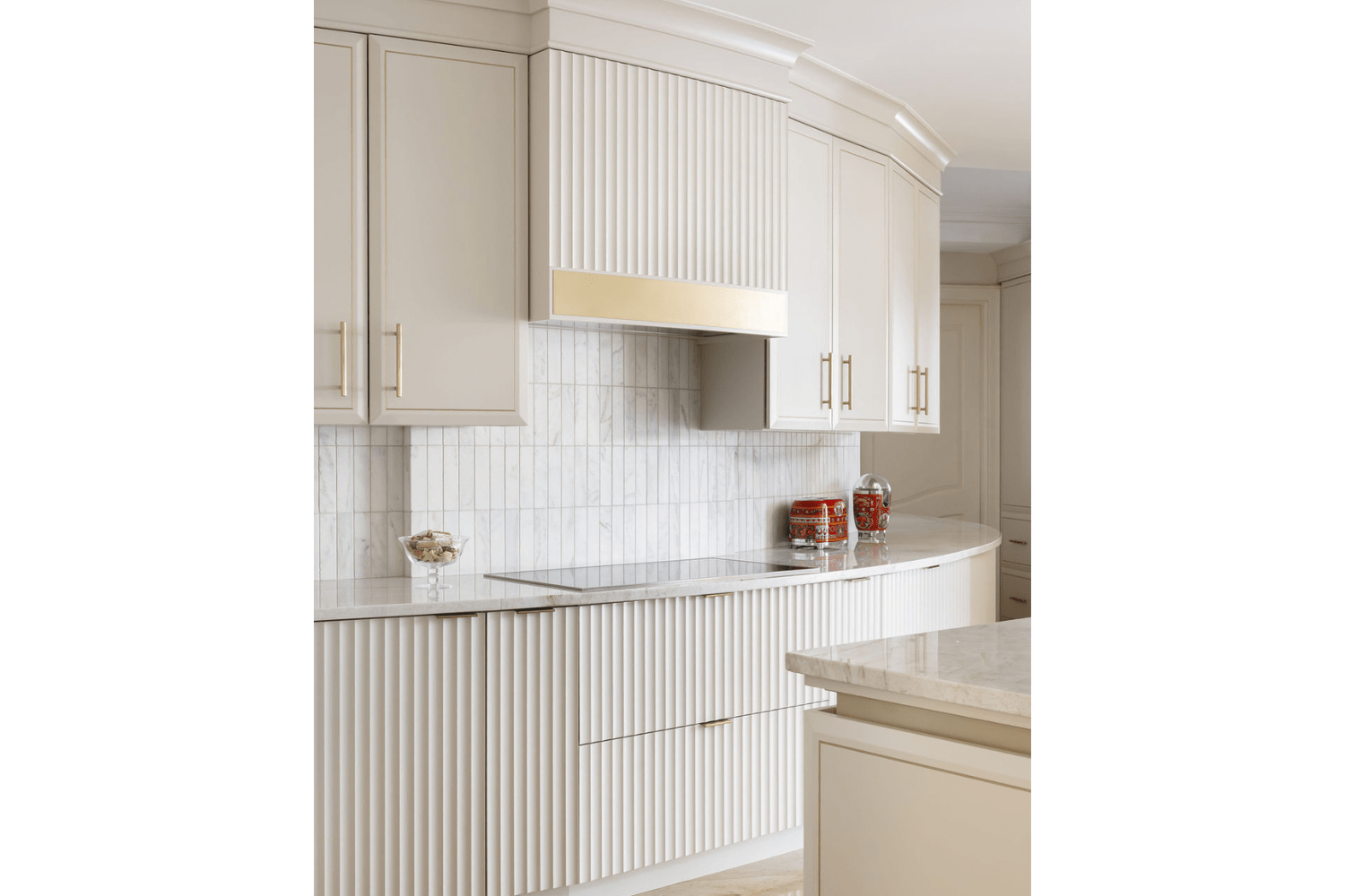 Fluted custom range hood with gold valance