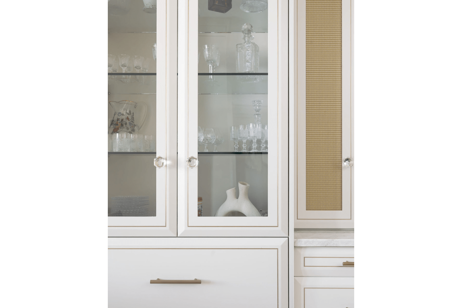 Glass shaker doors with gold inlay and glass knobs
