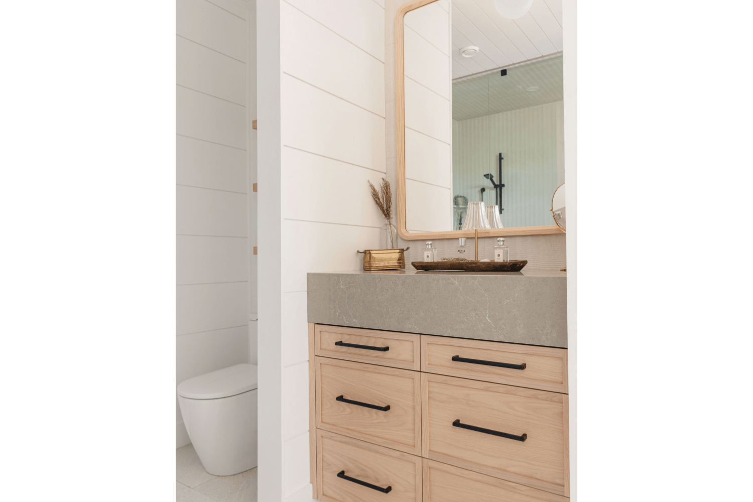 Guest ensuite white oak vanity with grey stone countertop