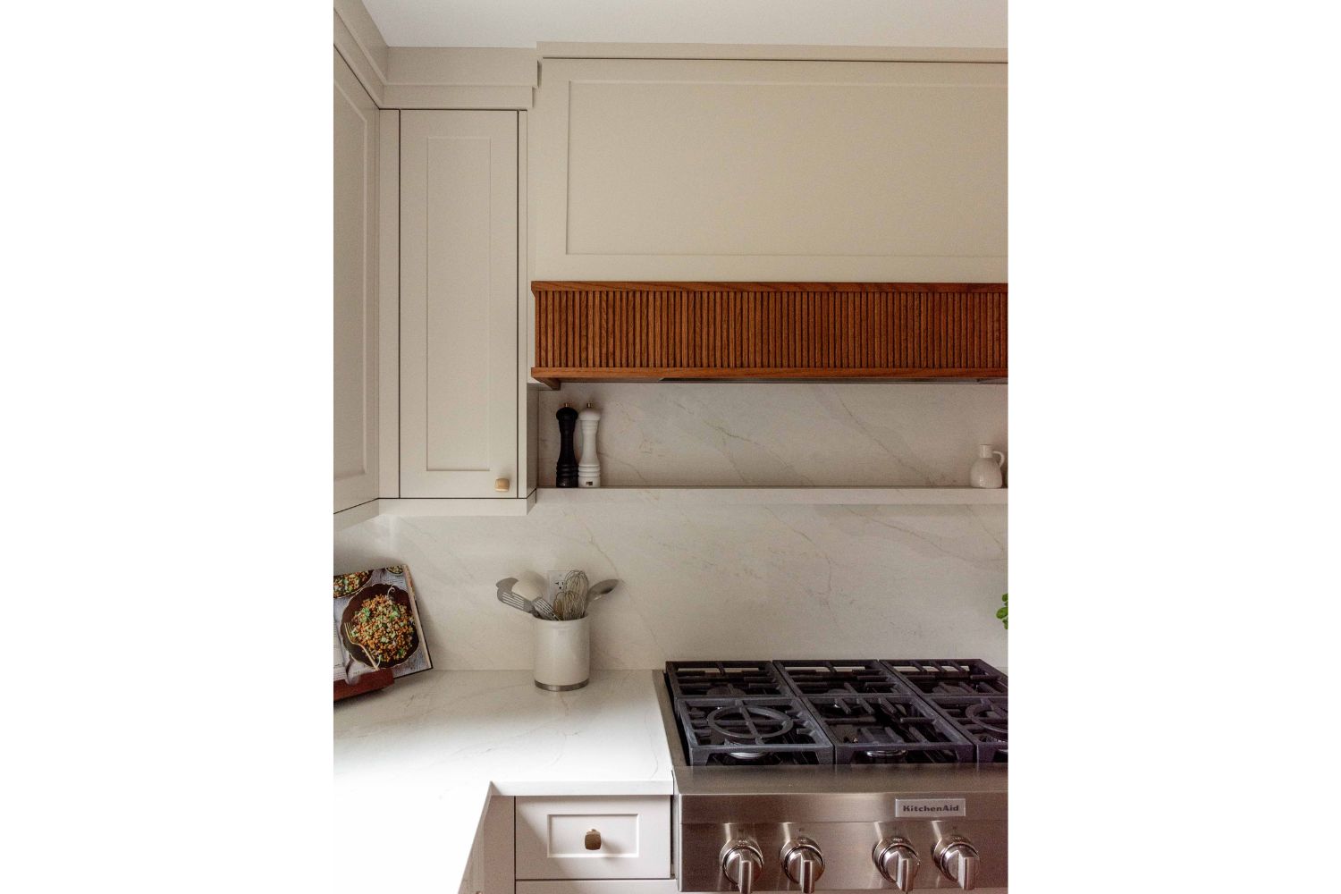 Slatted red oak accent on custom range hood