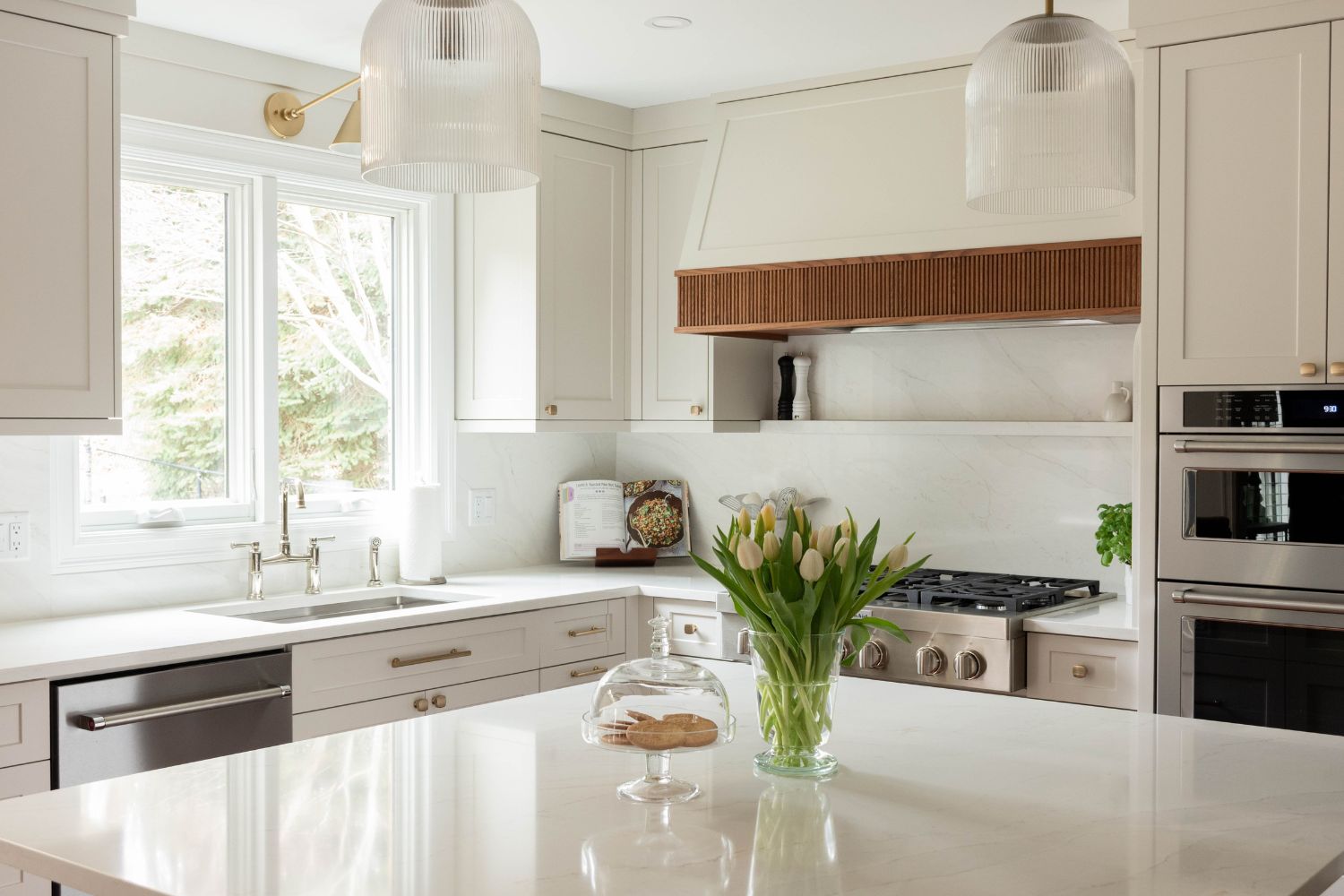 Transitional warm white kitchen design with wood accents