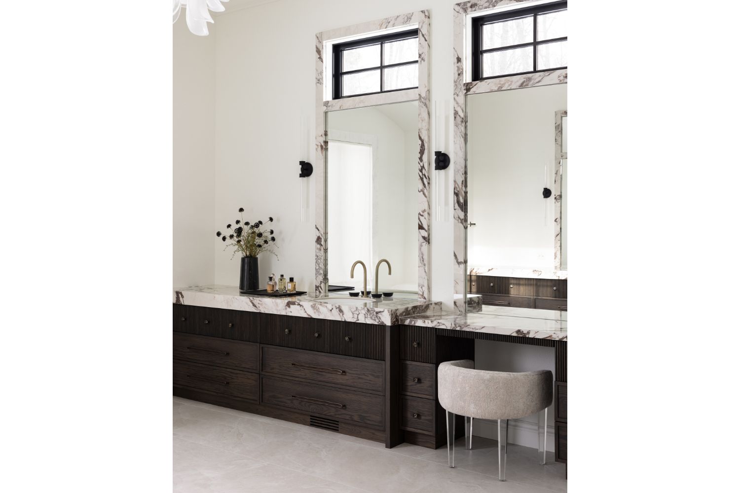 Dark brown bathroom vanity with marble countertop and bronze