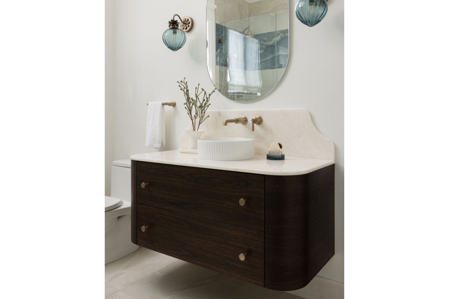 Floating curved walnut bathroom vanity with scuptural backsplash