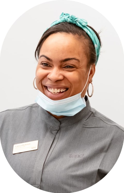 A Tend dental assistant is smiling.