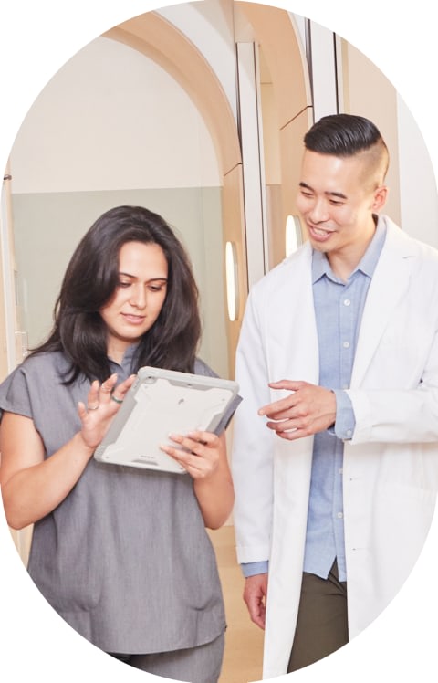 A Tend dentist is chatting with a team member while walking.