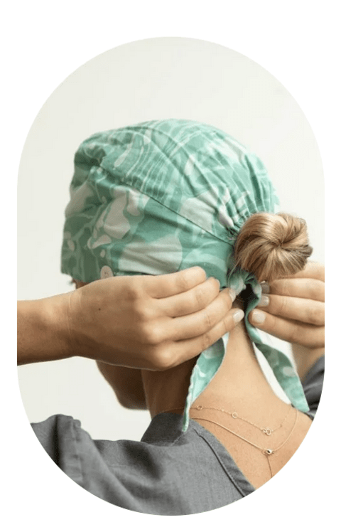 A Tend employee fastens a bandanna around their head.