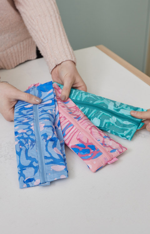 A Tend employee shows a guest brush bags.