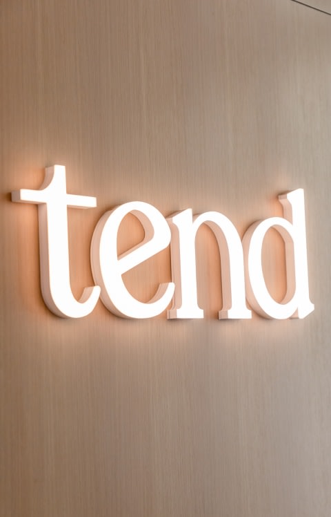 A glowing Tend sign.