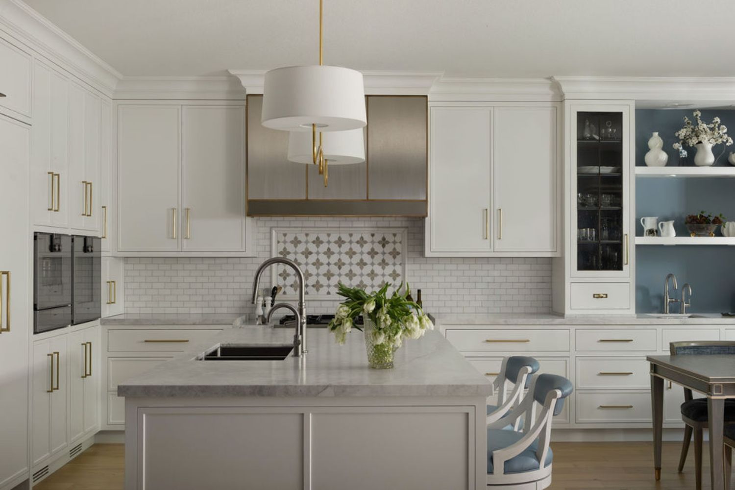 Transitional white kitchen with brass hardware and accents
