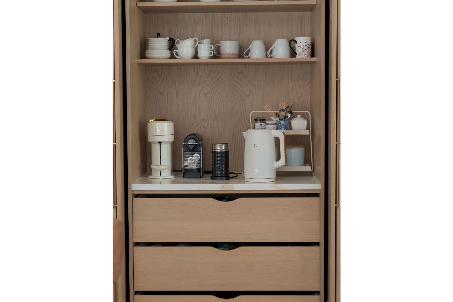 White oak coffee bar hidden behind pocket doors