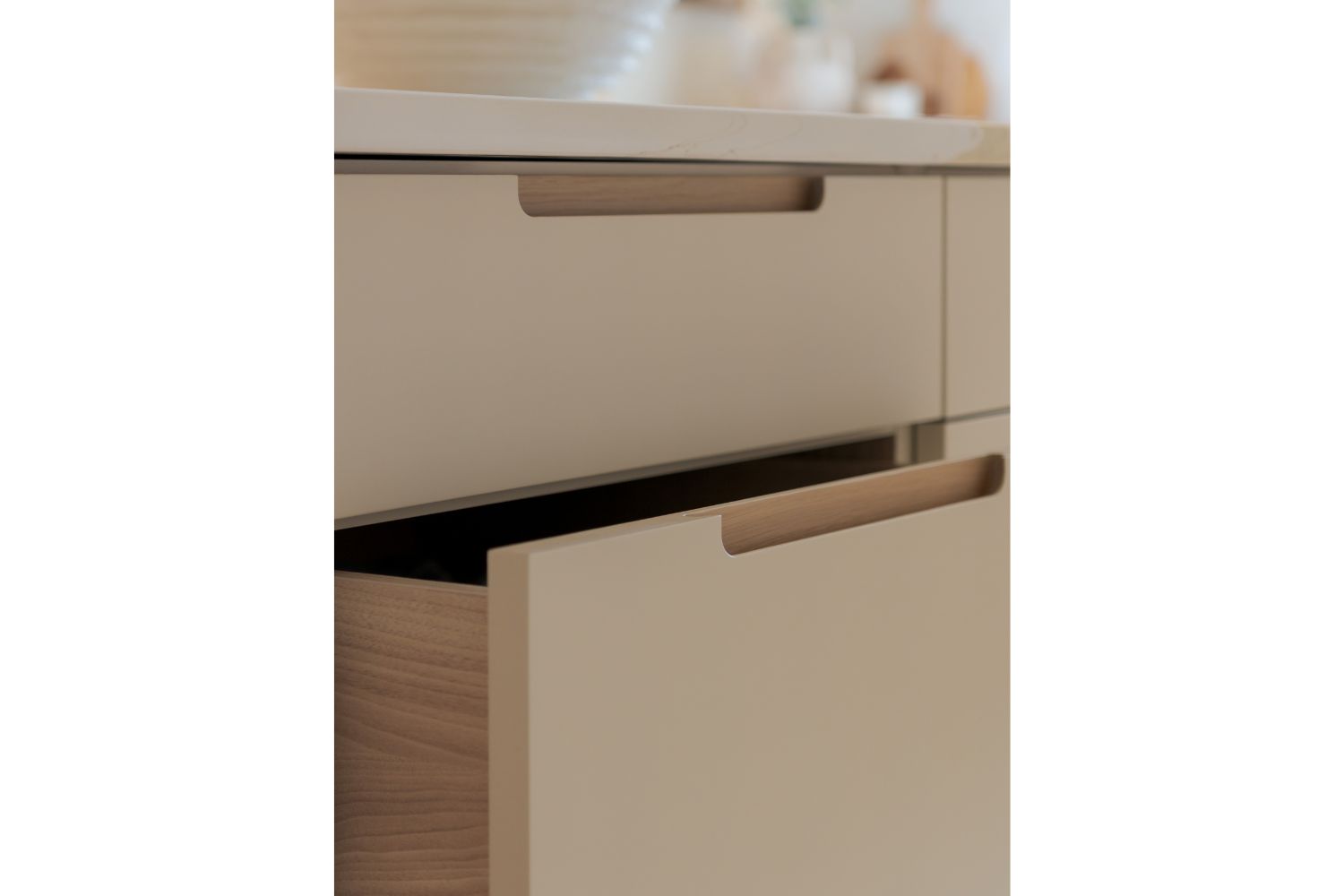 White oak integrated finger pull on cream drawers