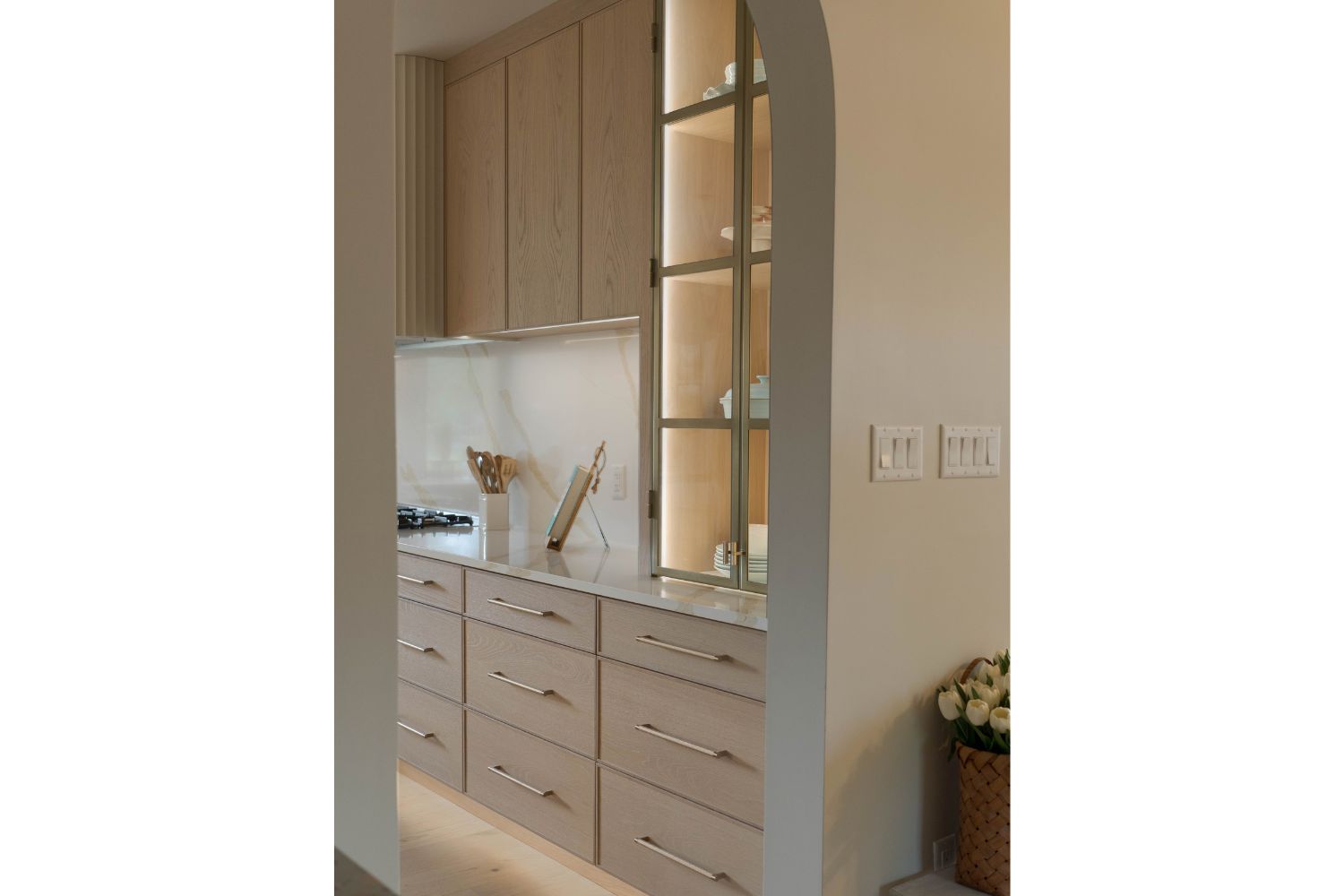 Arched kitchen entryway into contemporary white oak kitchen