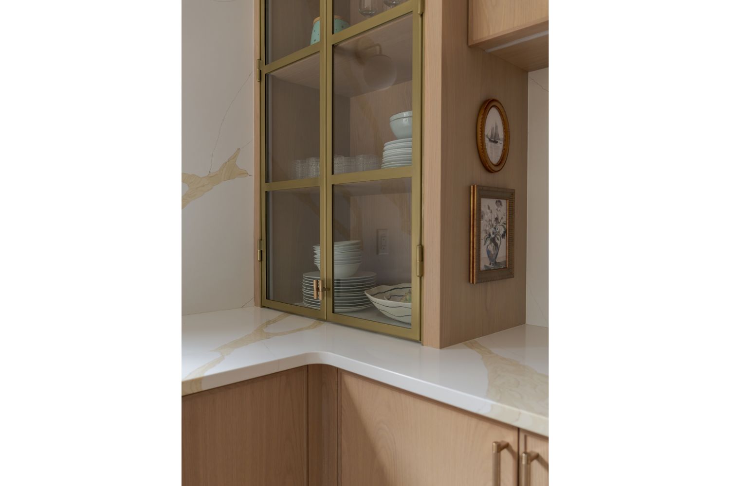 Contemporary countertop cabinet with gold metal framed glass doo